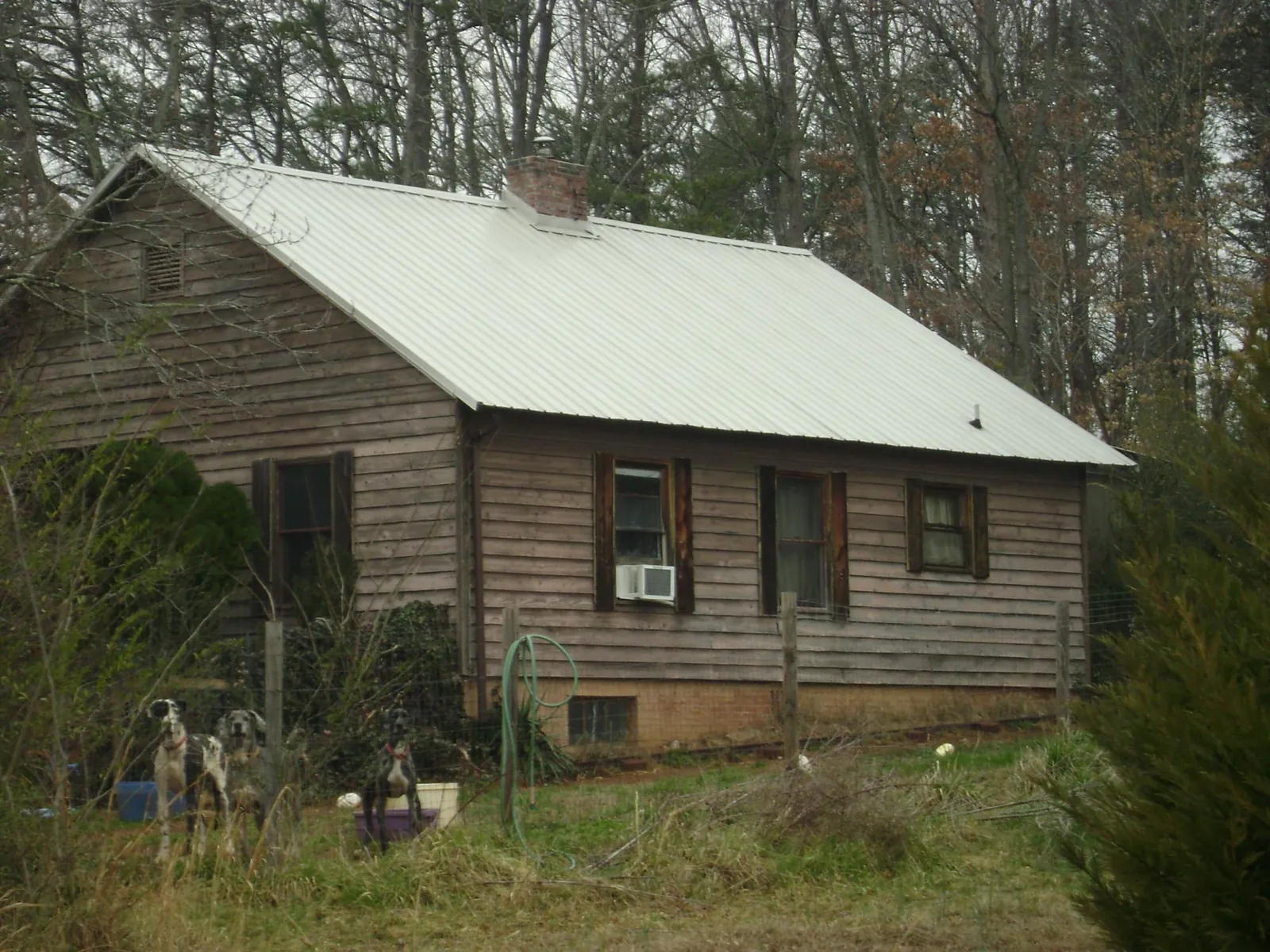 White metal roof on an old wood sided farmhouse, from a Asphalt Shingle Roof Repair job in Lynchburg